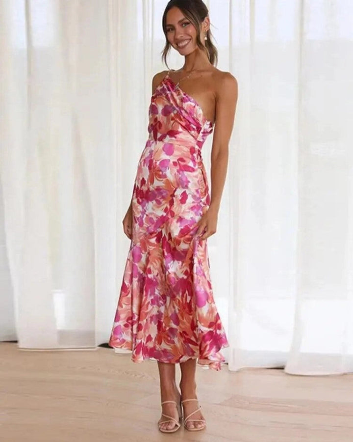 Female model showing feet wearing floral formal wear on a plain background.