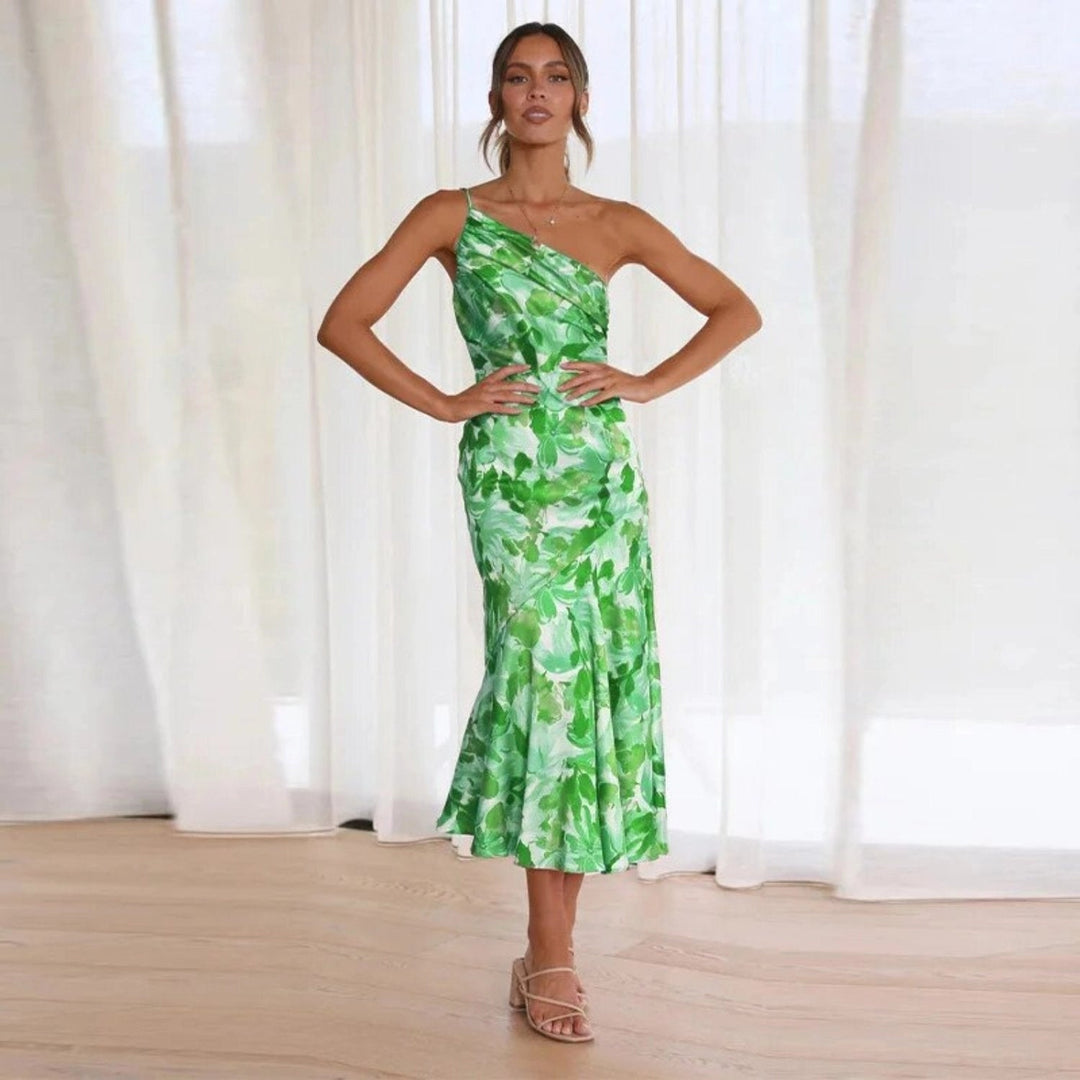 Female model in graceful floral formal clothing displayed on a plain backdrop.