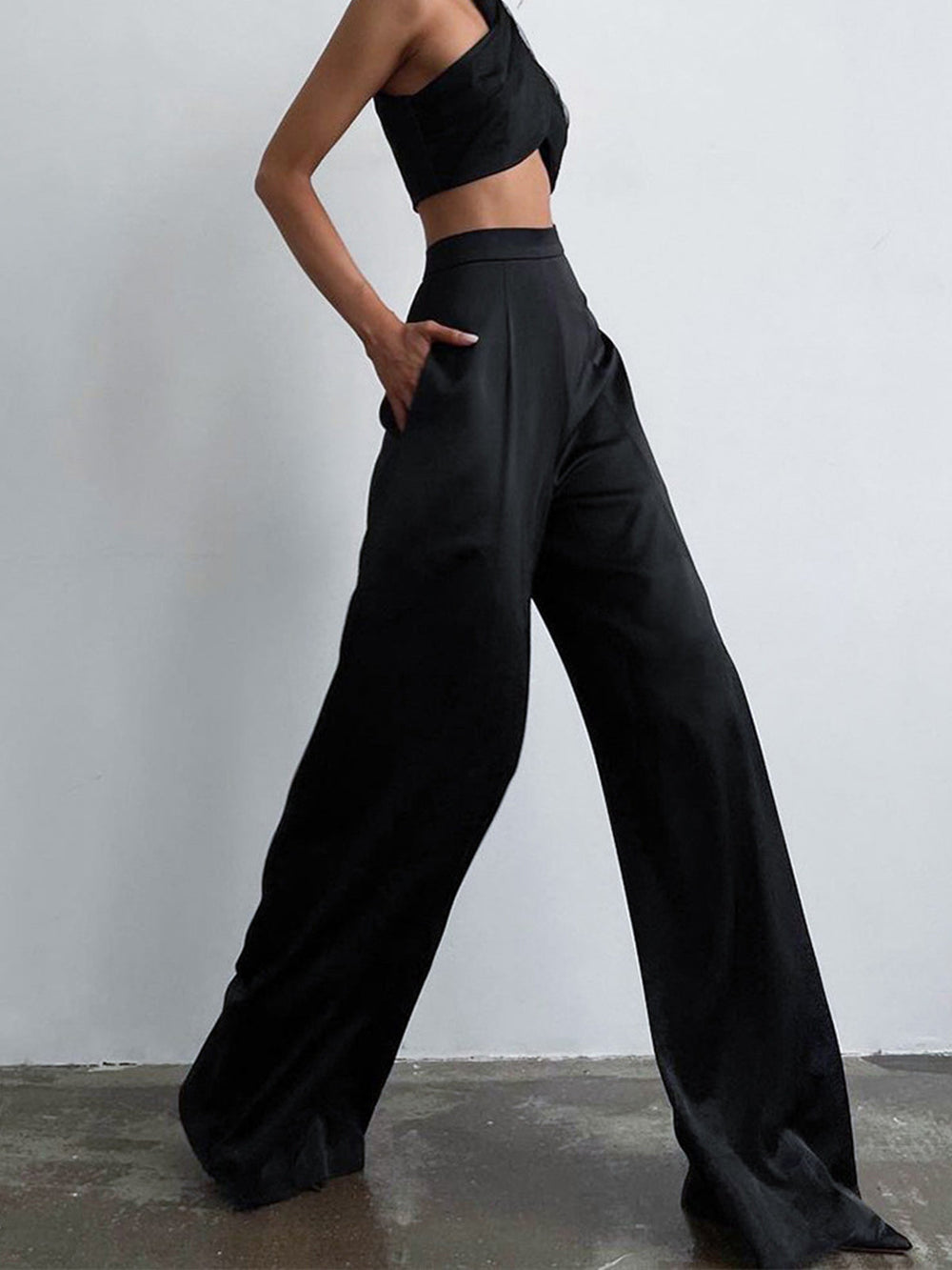Woman modeling regular fit long pants on a plain background.