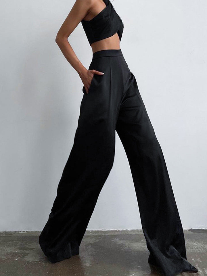 Woman modeling regular fit long pants on a plain background.