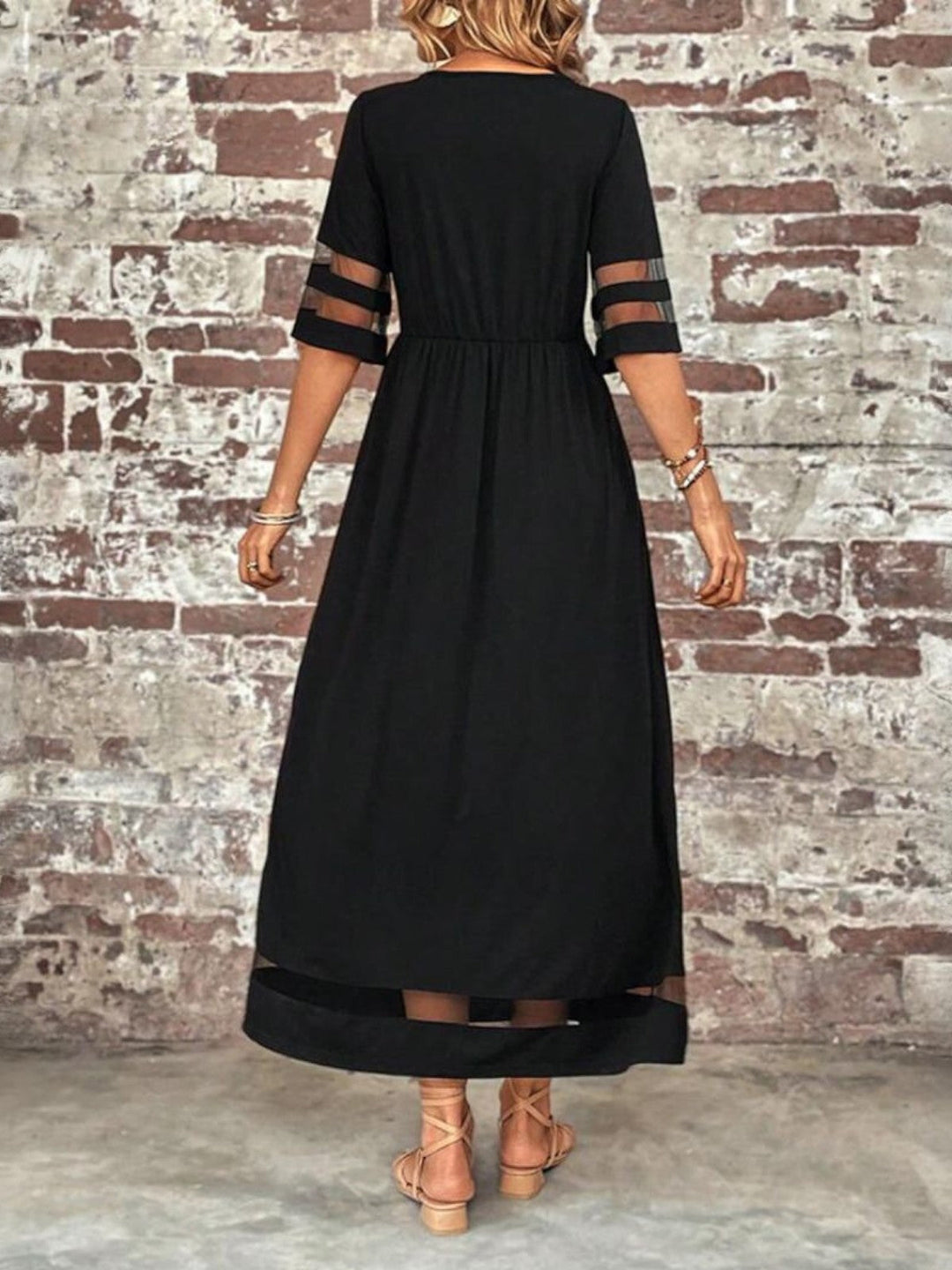 Outdoor back view fashion shot of black long dress