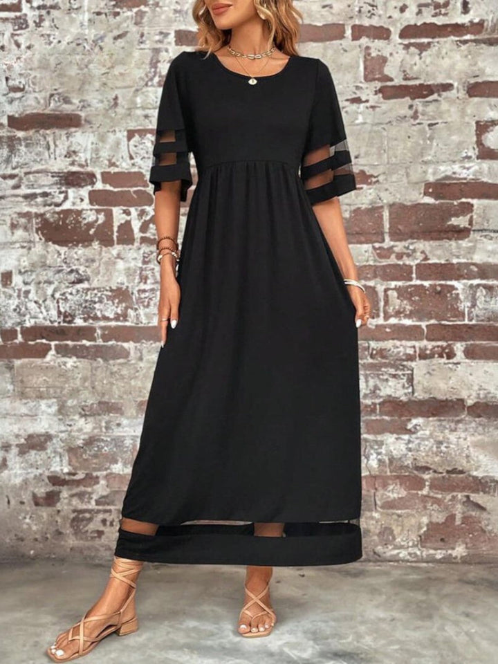 Stylish maxi dress against rustic backdrop