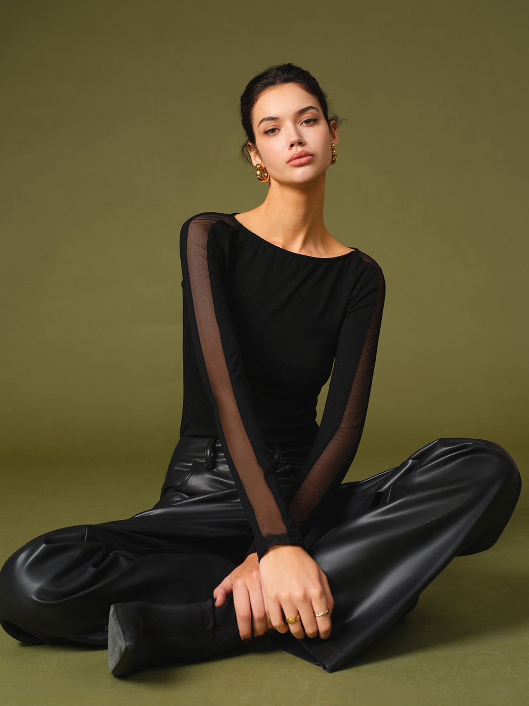 Adult model wearing a modern casual t-shirt with sheer mesh sleeve detail.