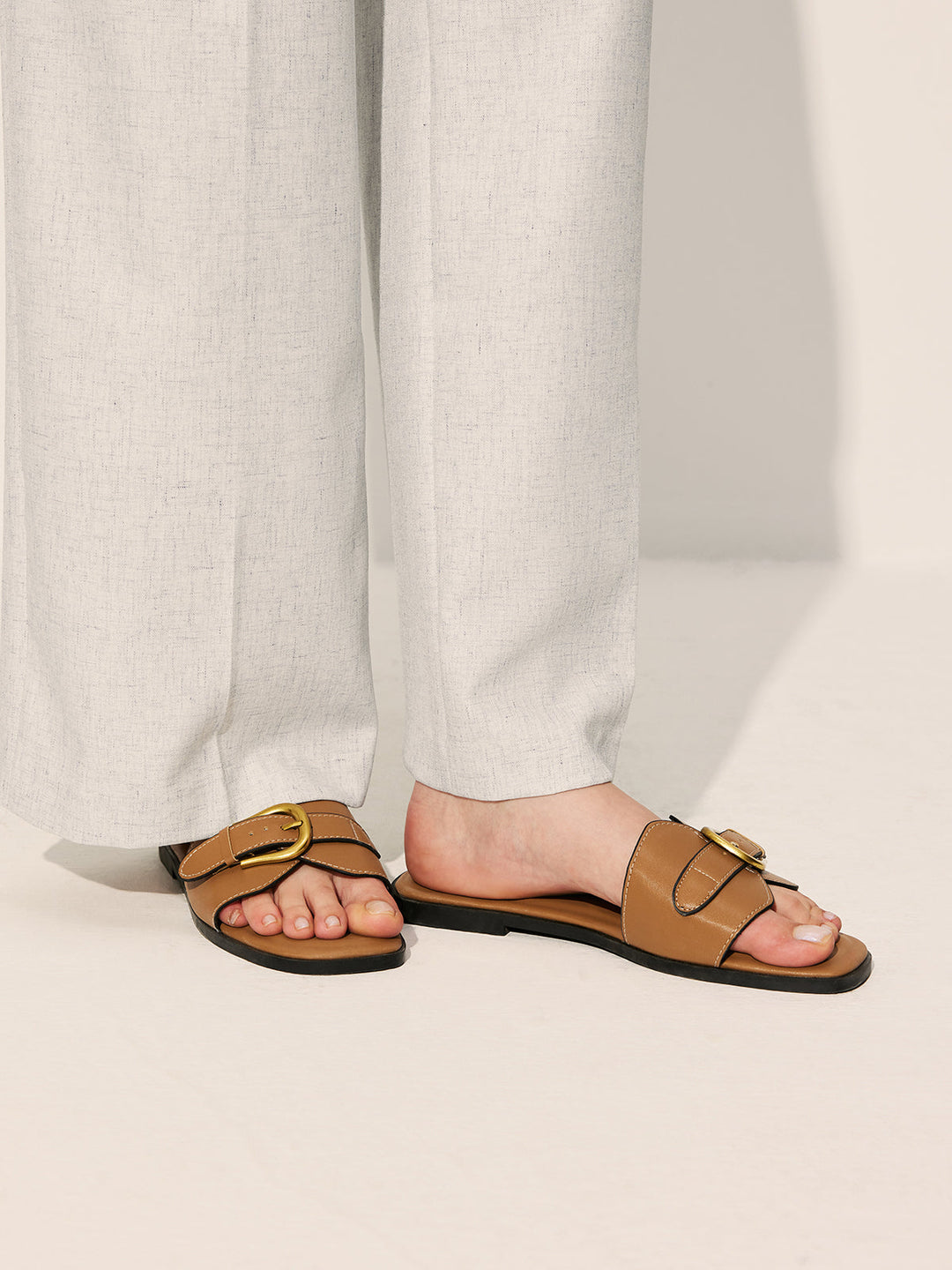 Top view foot in sandals on plain background simple composition