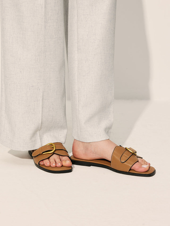 Top view foot in sandals on plain background simple composition