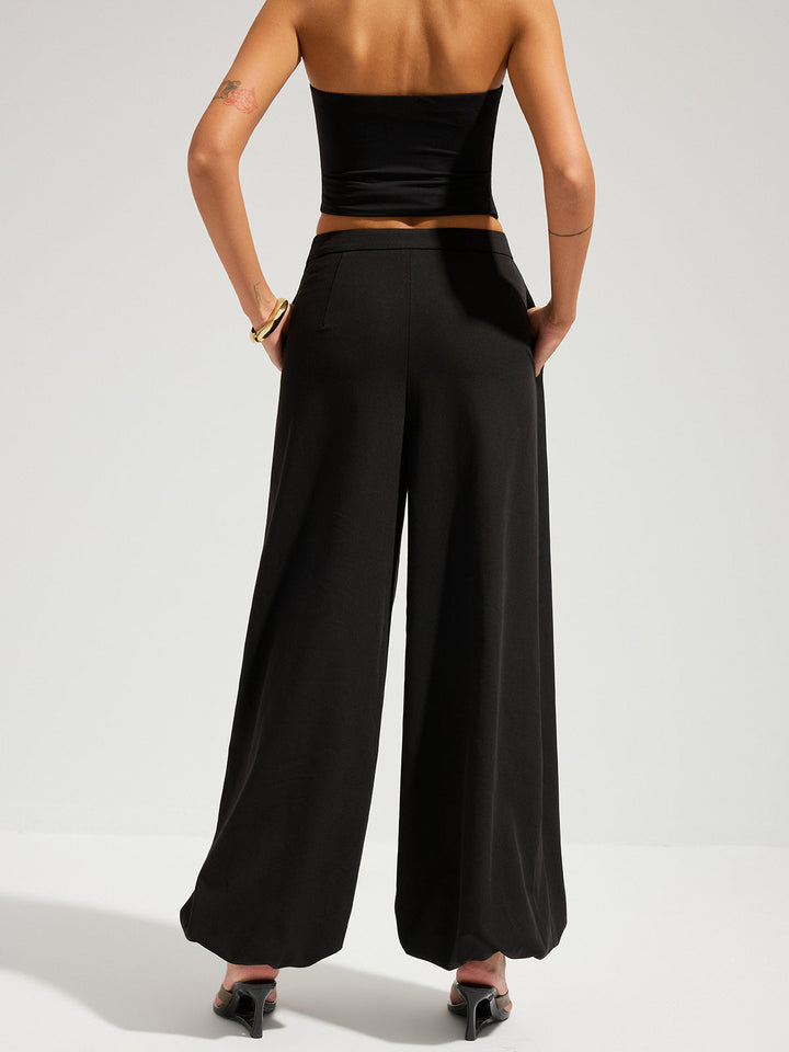Female model showing a long tailored skirt against a plain background.