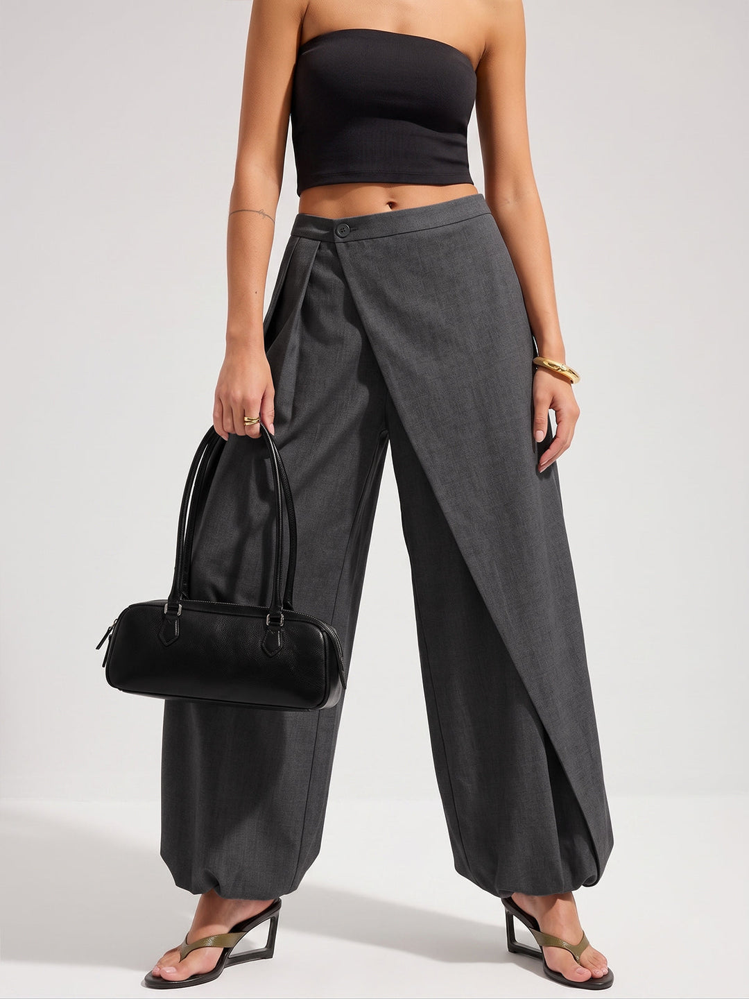 Woman wearing a clean-cut long skirt on a plain background.