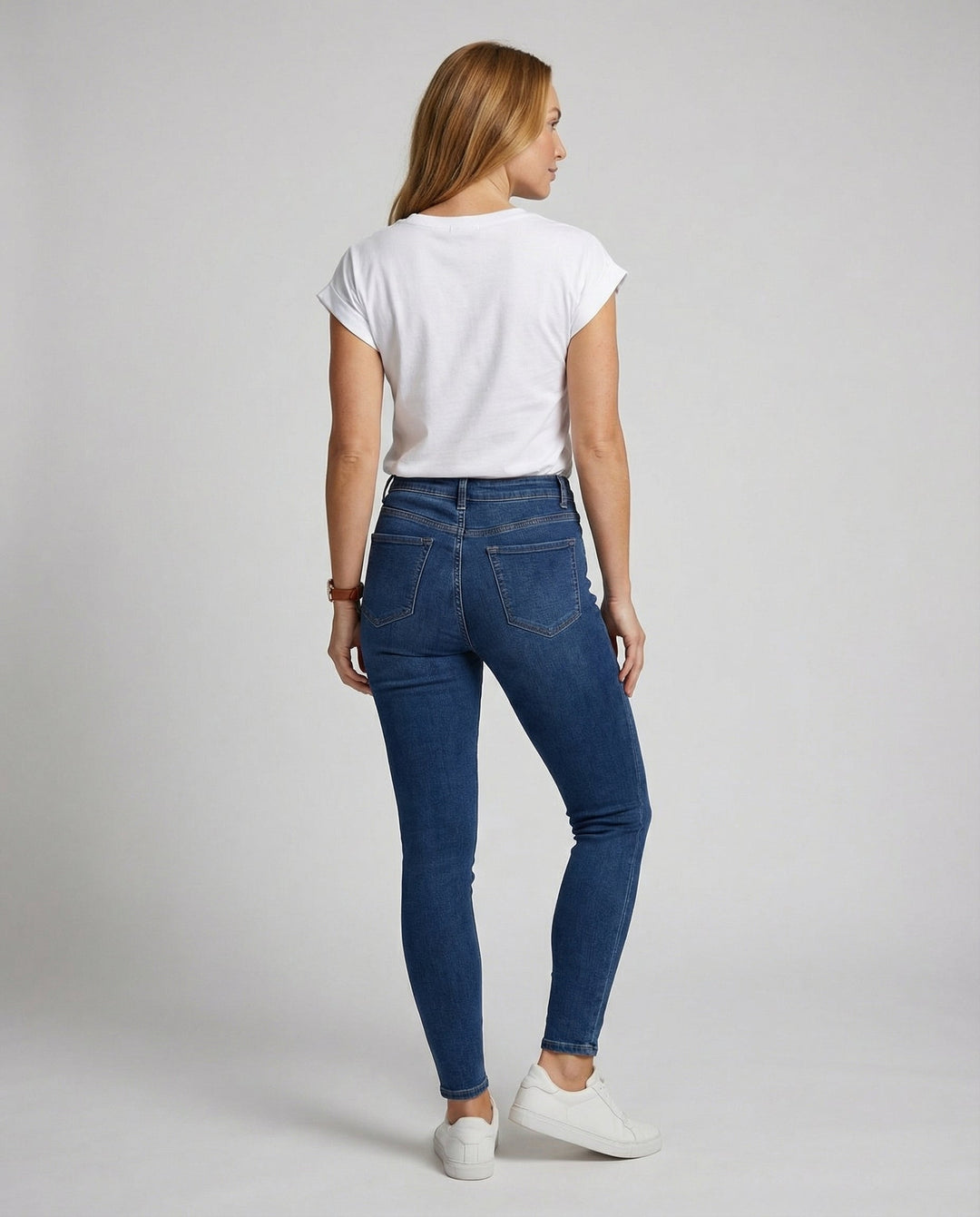 Woman in a relaxed fit casual T-shirt styled on a plain background.
