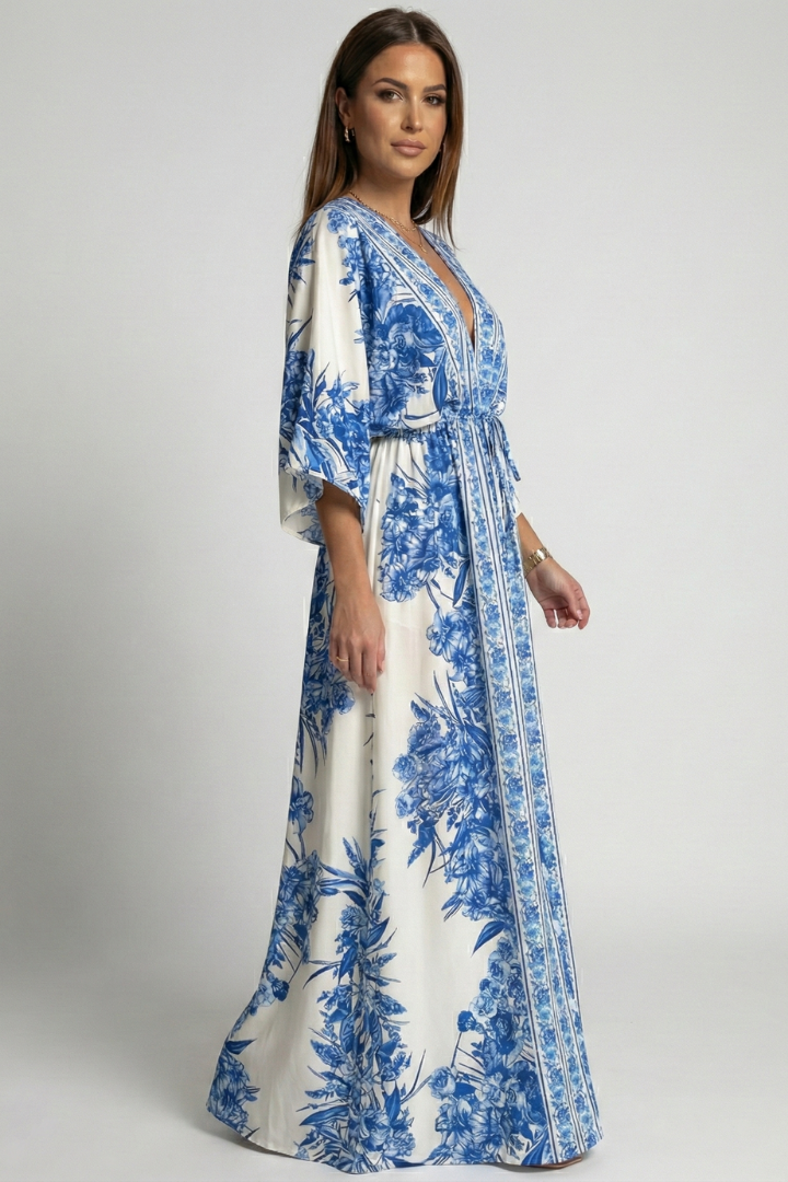 Female model showing flowing long dress with bell sleeves front.