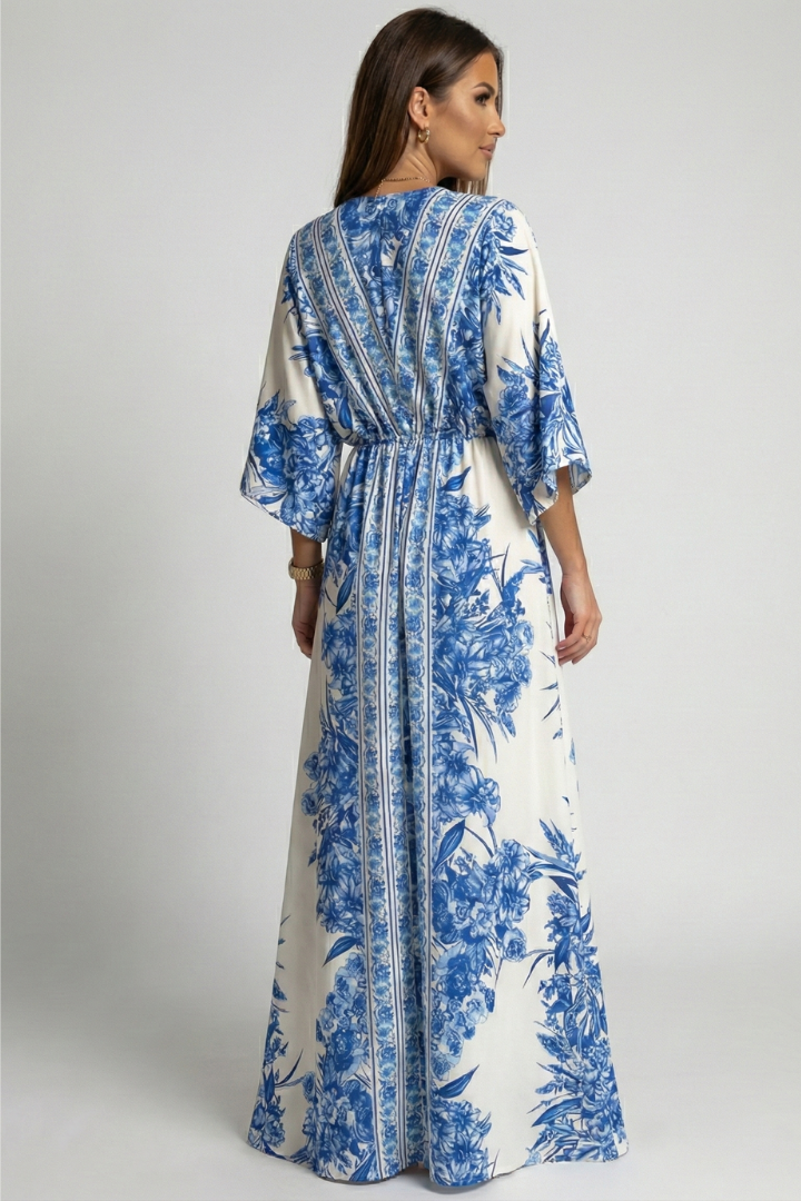 Female model wearing blue and white dress full back view.