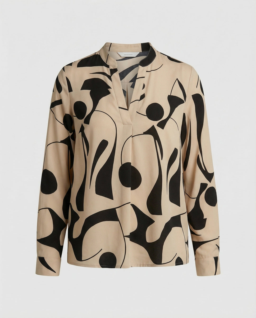 Woman wearing a versatile blouse suitable for work and casual occasions.
