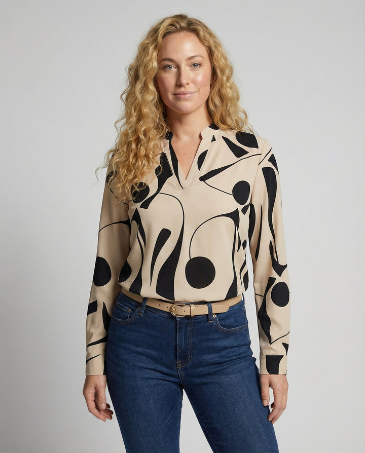 Female model wearing an elegant women’s blouse against a plain background.