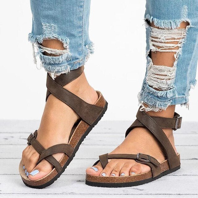 Woman wearing adjustable casual sandals on a plain background.