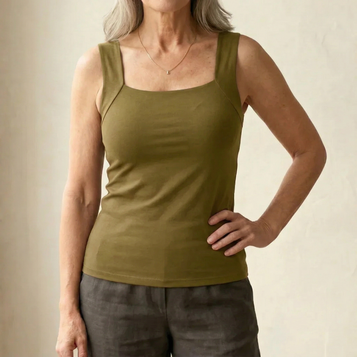  Woman displaying a modern square neck top with a flattering fit on a plain background.