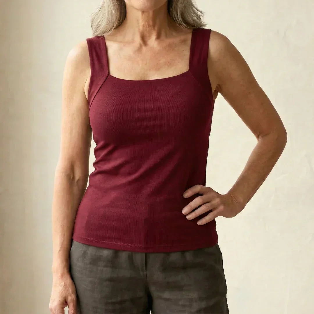 Female presenting a versatile square neck tank with a sleek appearance on a plain background.