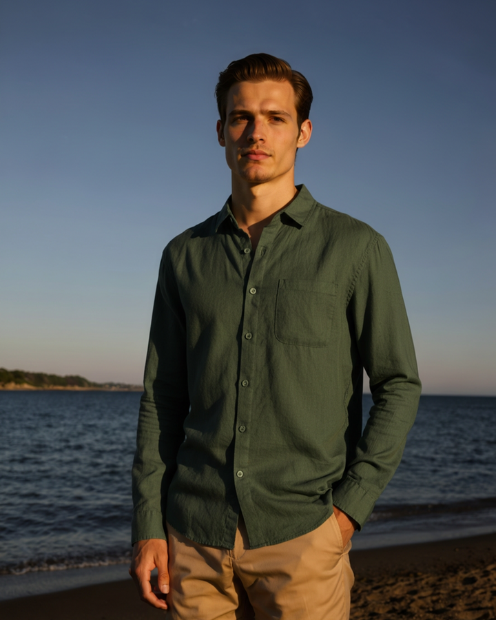  Male model styling a casual collared shirt against a plain background.