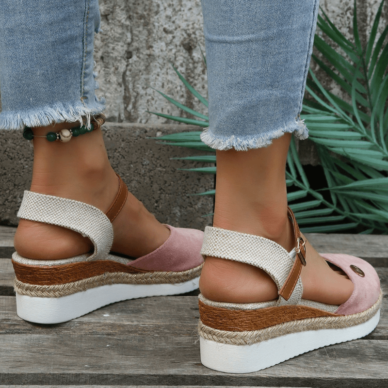 Back angle of wedge sandals worn with relaxed foot pose