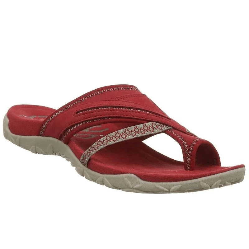 Foot model walking pose showing sandal grip plain white background