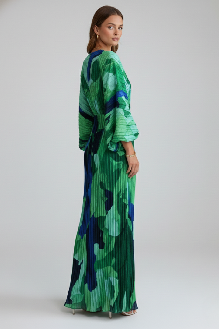 Female model displaying gathered waist dress with pleated skirt.