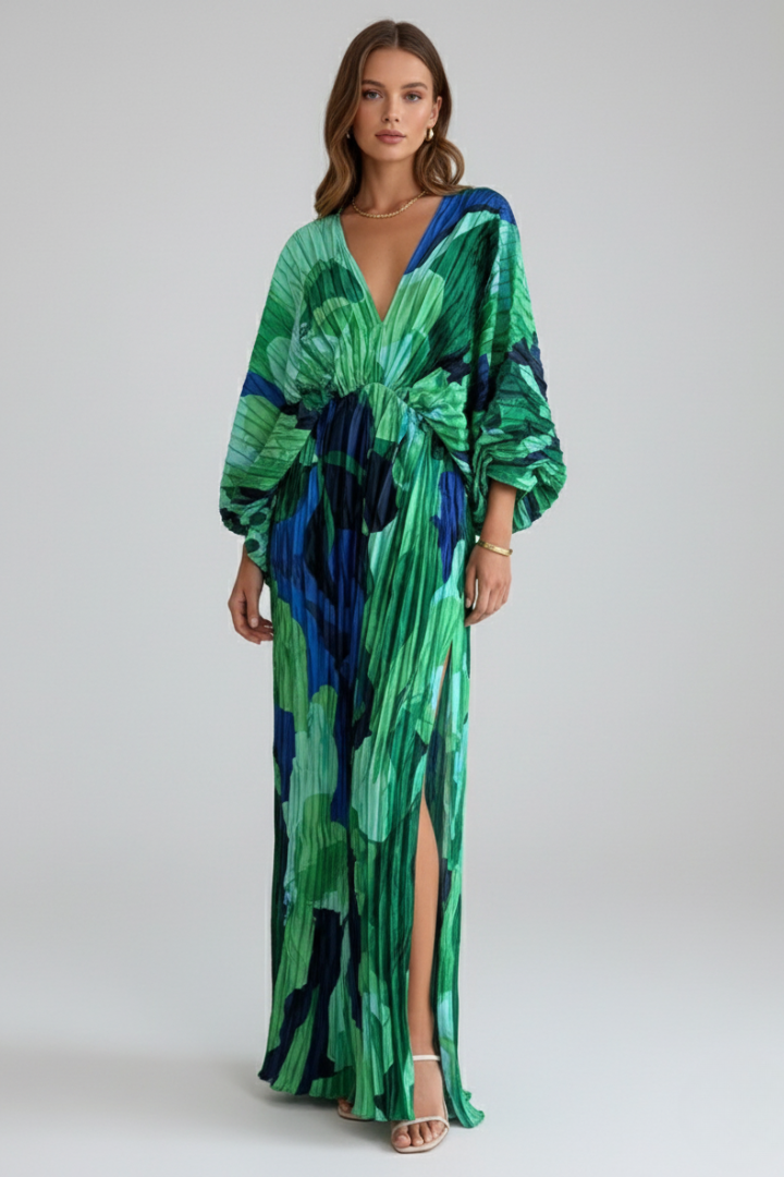 Female model showing front view of long printed dress gracefully.