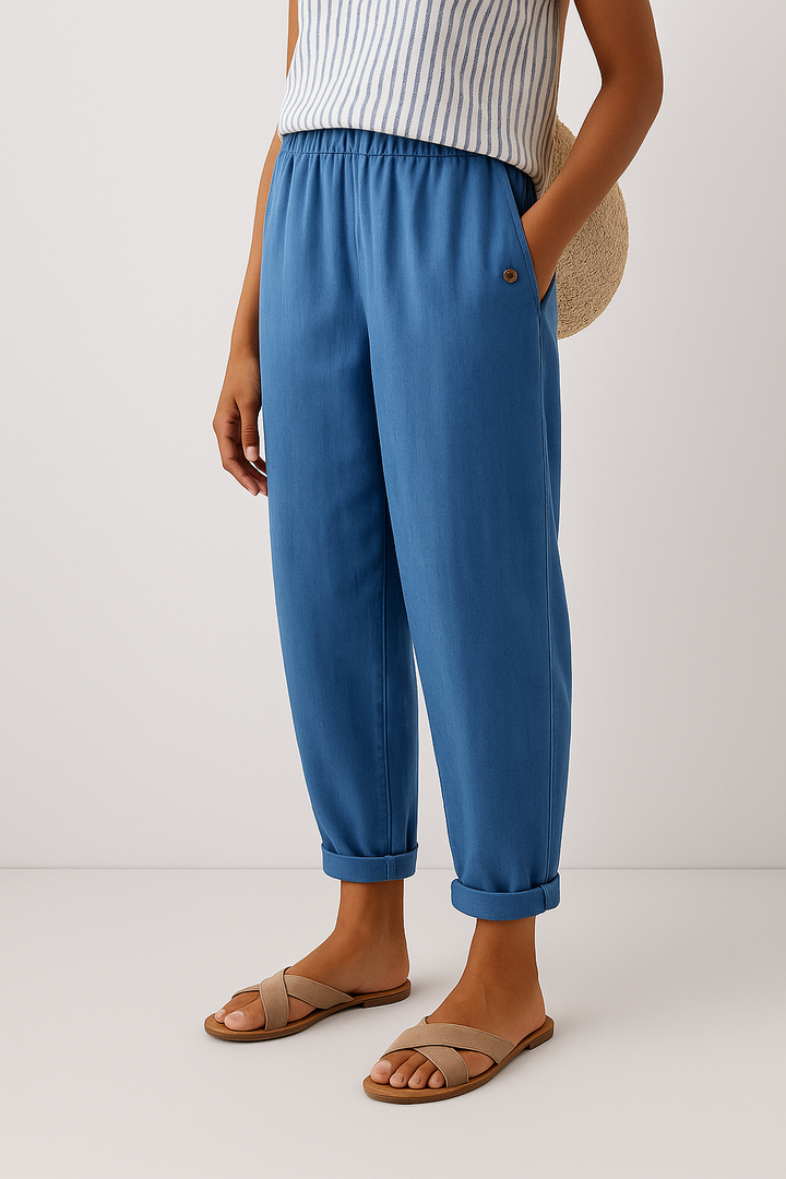  Woman showcasing casual cropped trousers with a pull on waist on a plain background.