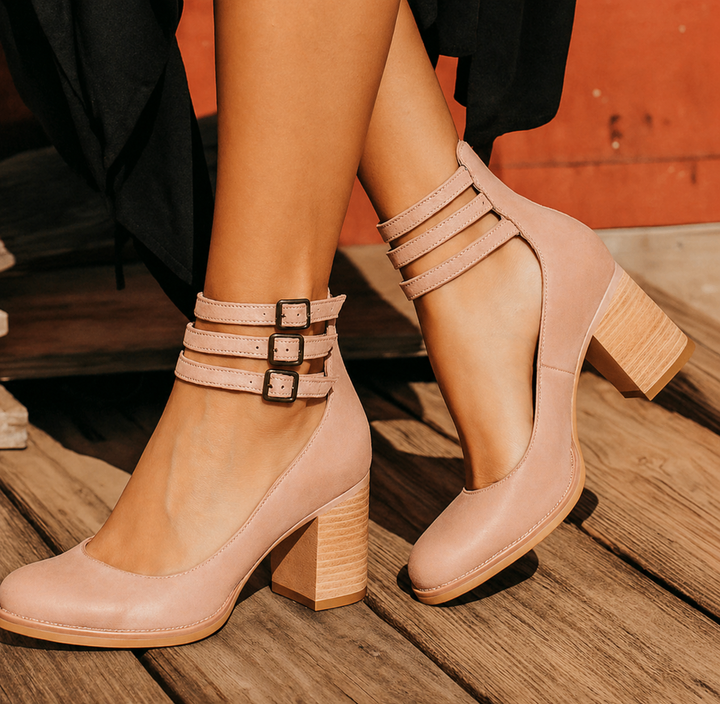  Model wearing refined sandals photographed on a plain background.