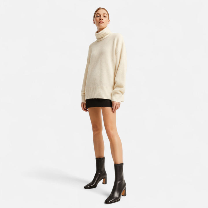 Woman wearing matte ankle boots with a side zip design on a plain background.