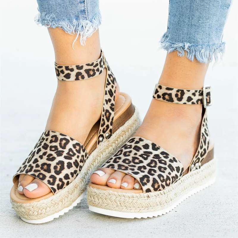 Foot standing naturally showing balanced wedge sandal design clearly