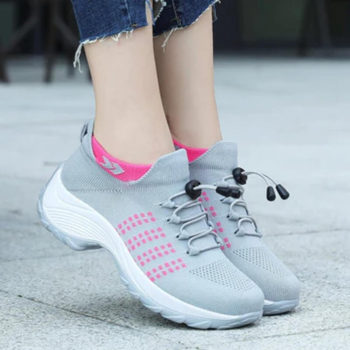 Side angle elevated grey and pink sneakers with thick white midsoles