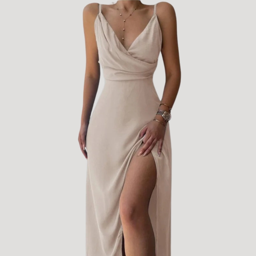 Model standing side angle showcasing slit detail on plain background