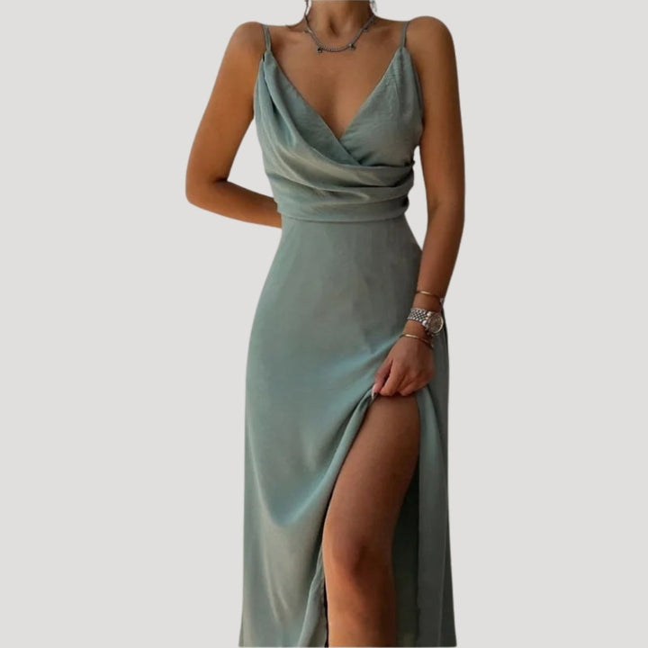 Model walking pose showing movement of slit dress plain background