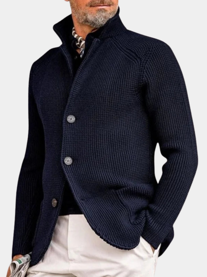 Male model wearing a light linen suit on a plain background.