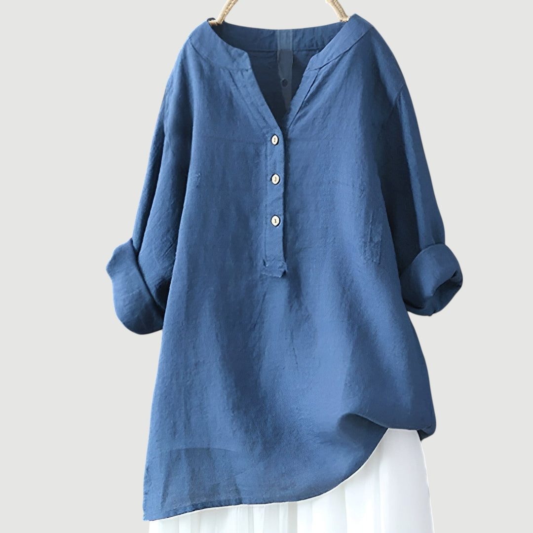 Simple women’s linen blouse with airy comfort on plain background.