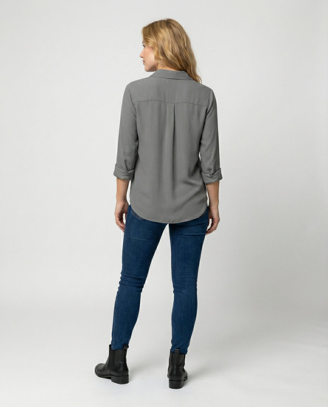 Female model in an elegant long sleeve blouse with a collared neckline.
