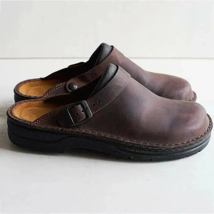 Pair of brown clogs on a white background