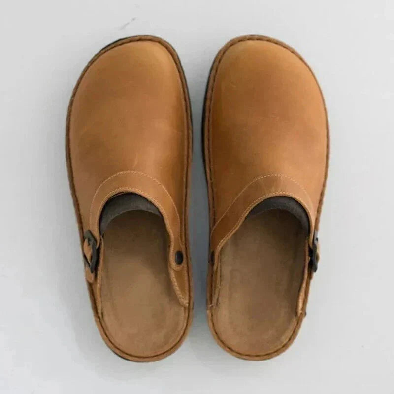 Pair of brown clogs on a white background