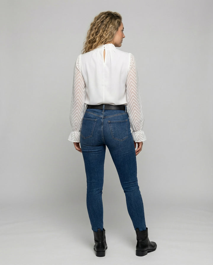 Female model in an elegant long sleeve blouse suitable for work and casual wear.