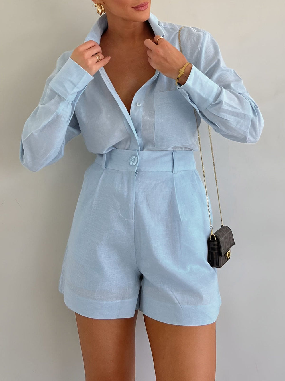 Female model wearing a relaxed matching long sleeve set on a plain background.