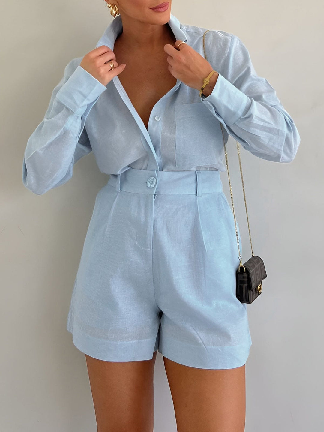 Female model wearing a relaxed matching long sleeve set on a plain background.