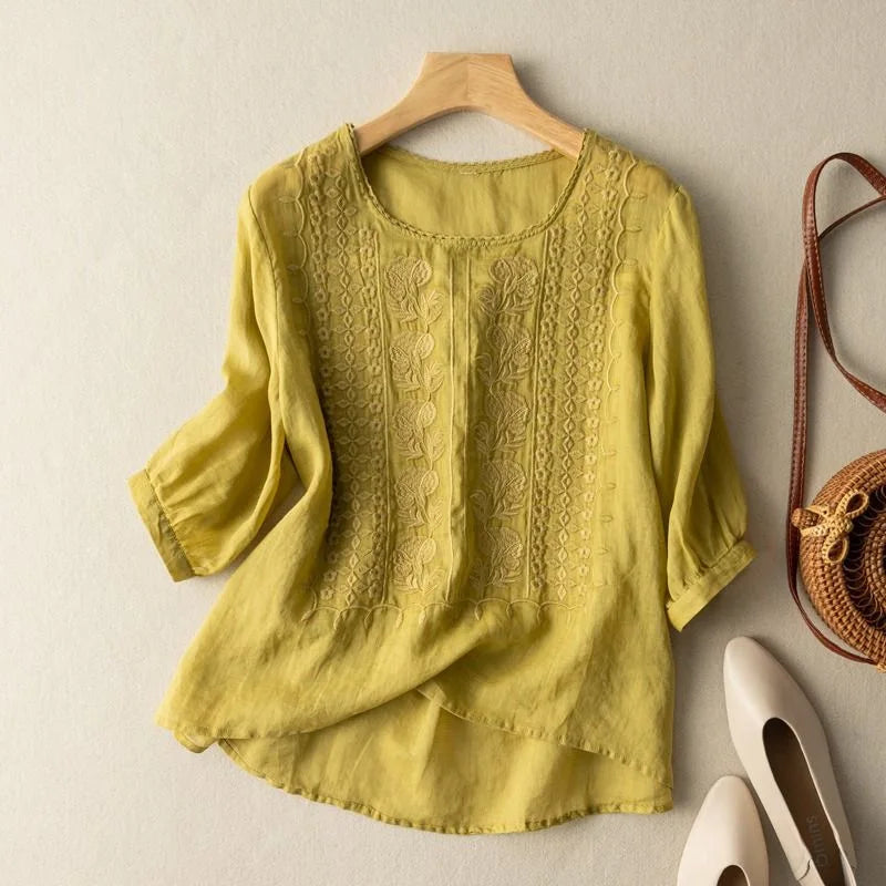 Relaxed-fit blouse with front embroidery and neat cuffed sleeves for casual or work outfits.