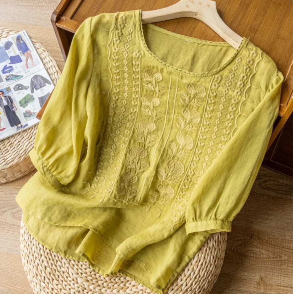 Everyday women’s blouse featuring embroidered detail and lightweight fabric on a hanger.
