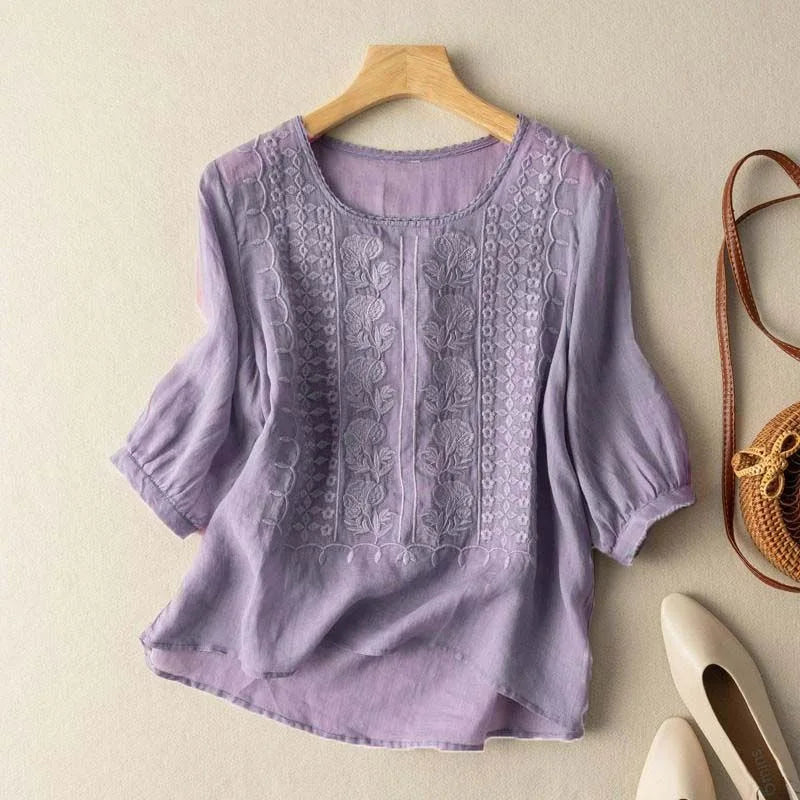 True-to-size embroidered blouse displayed on hanger for versatile daily styling.