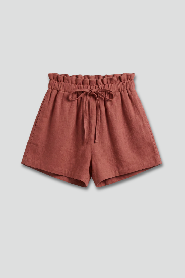 Stretchy shorts with drawstring on plain gray background.