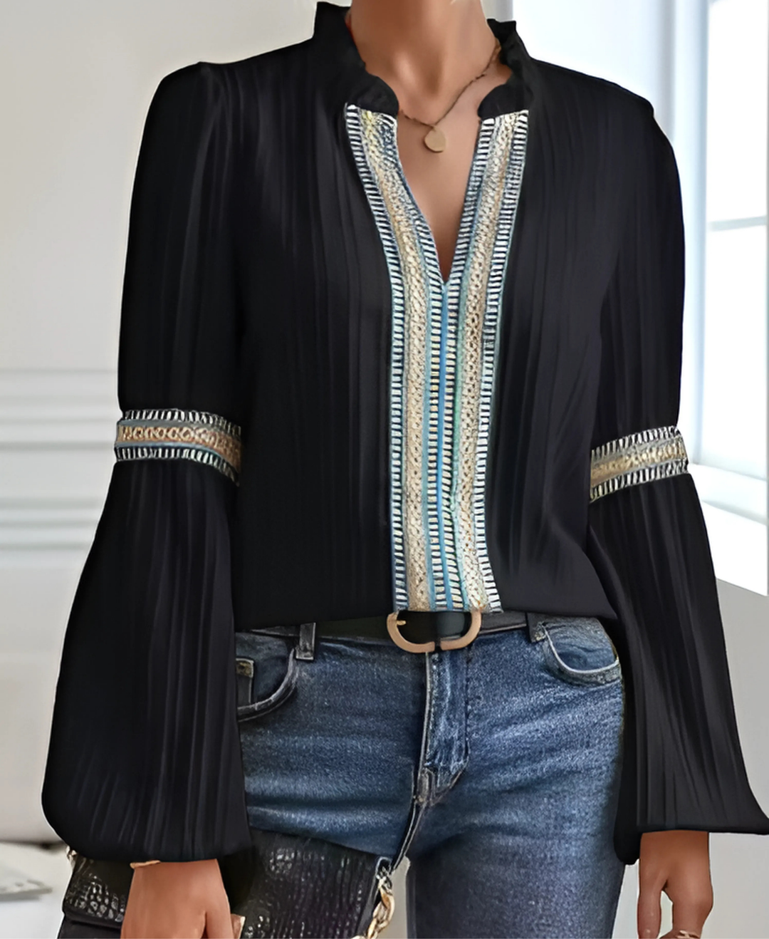 Woman wearing an elegant V-neck blouse with a clean background.