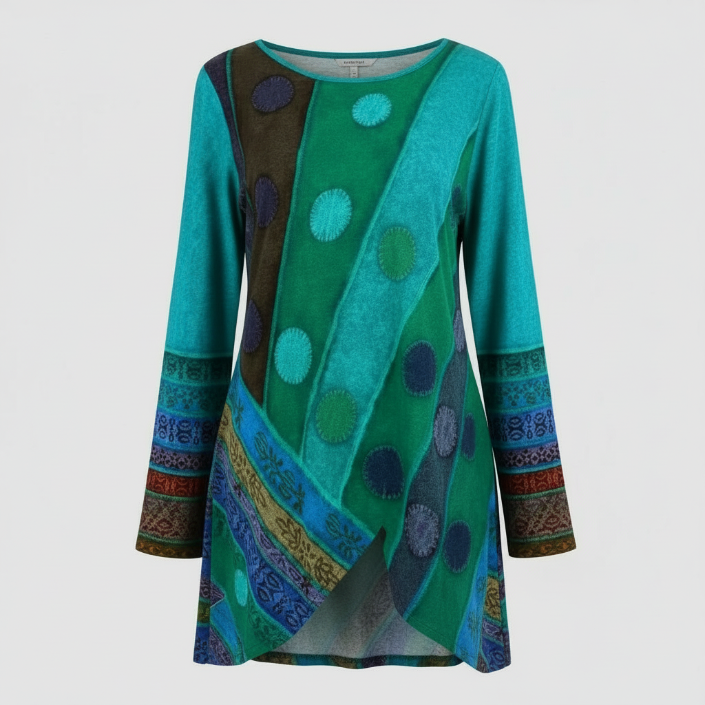 Female model wearing a colourful long-sleeve tunic on a plain studio background.