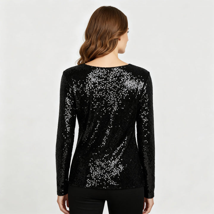 Female model in a shimmering sleeveless top with an elegant V-neckline.