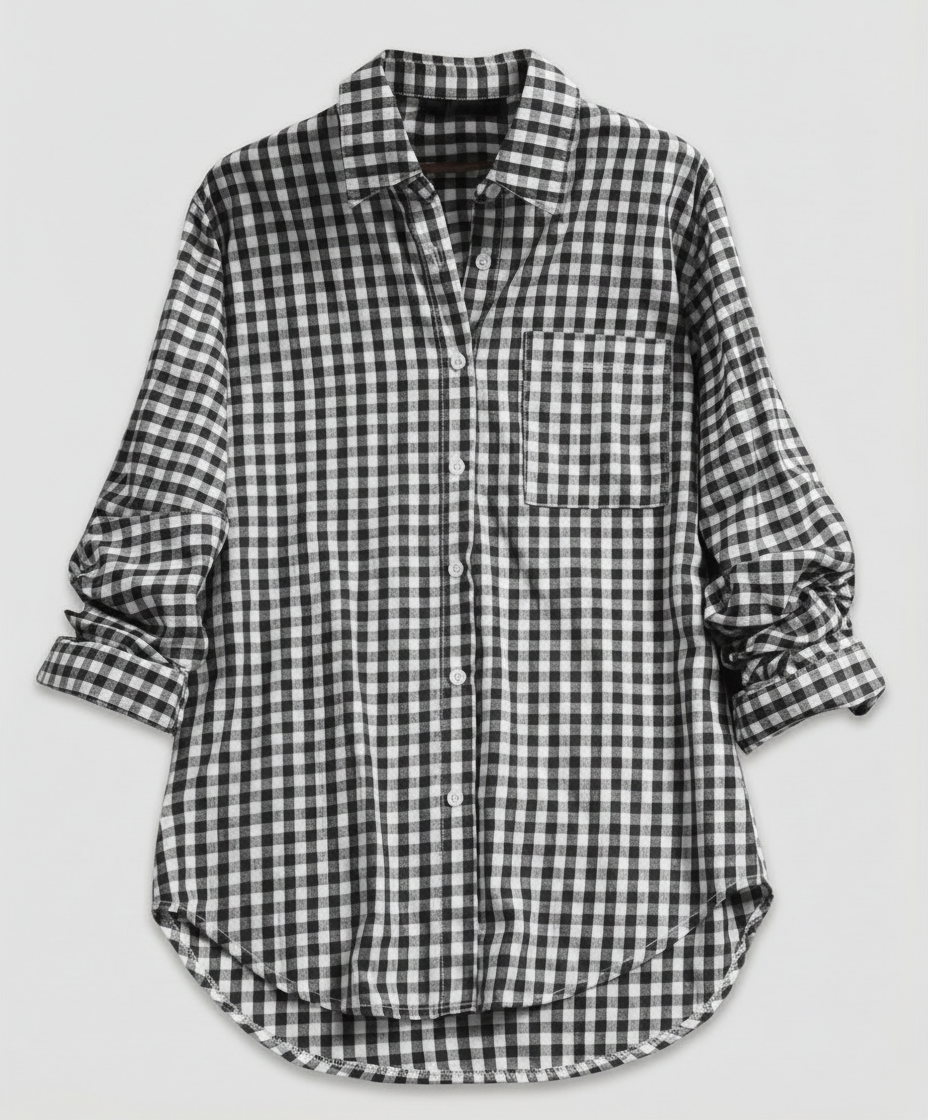 Woman showcasing a classic plaid shirt with a loose silhouette on a plain background.