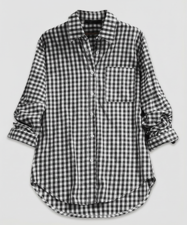 Woman showcasing a classic plaid shirt with a loose silhouette on a plain background.