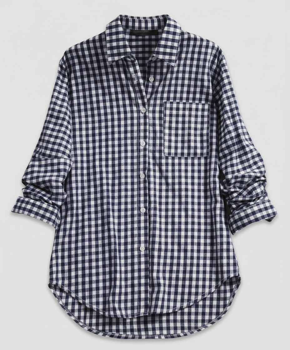 Woman wearing a relaxed-fit plaid shirt with a button-front design on a plain background.