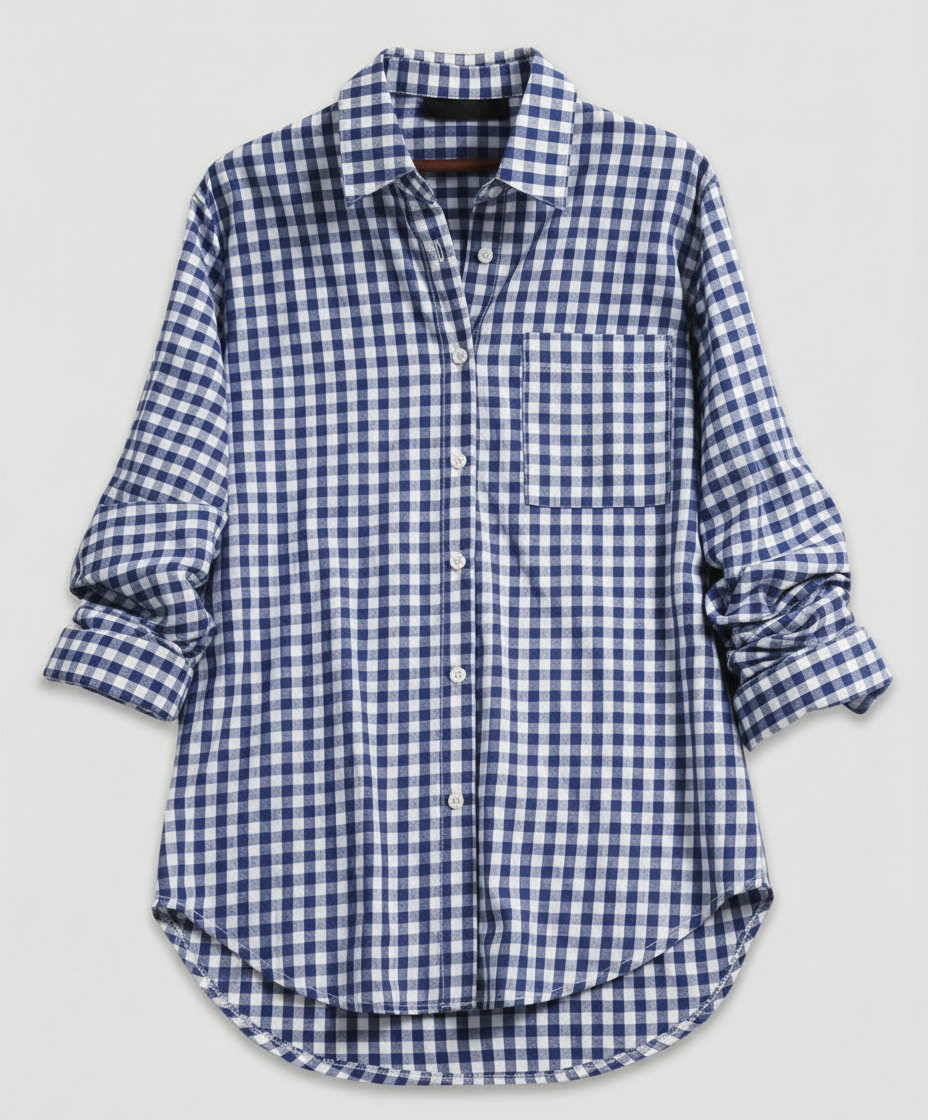 Woman in a classic plaid shirt layered over casual clothing against a plain background.